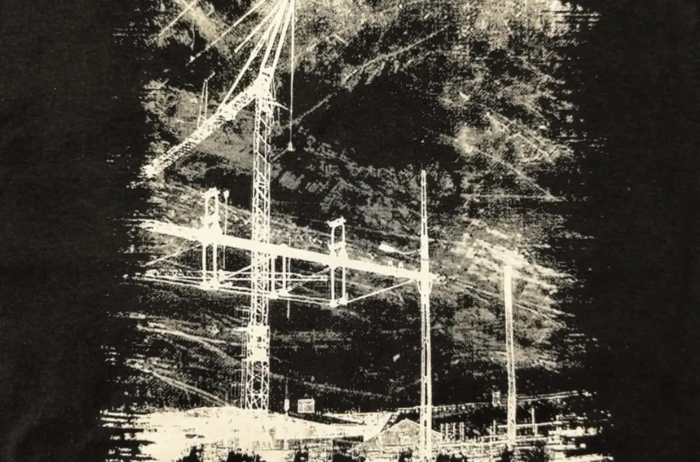 Album cover with a black background, black-and-white faces along the bottom, and white power lines in the center.